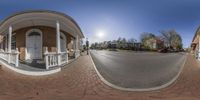 an image of a street taken from inside the fish eye lens of an outdoor area