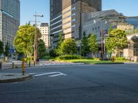 an empty road with a street sign at the curb in front of an office building