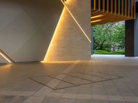 a hallway with columns on the wall that have led lights coming out of them and a door is behind the wall