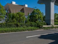 the city of richmond has long white arrows running down it's side and a pedestrian crossing over an expressway