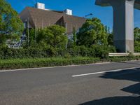 the city of richmond has long white arrows running down it's side and a pedestrian crossing over an expressway