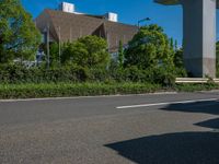 the city of richmond has long white arrows running down it's side and a pedestrian crossing over an expressway