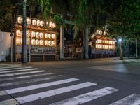 a street with several rows of lamps on either side of the road, two people crossing over a street