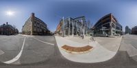 a 360 view looking up at buildings at the intersection of a street corner with some buildings around it