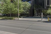 a picture of a city street with parked cars on it and a building across the road