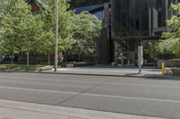 a picture of a city street with parked cars on it and a building across the road