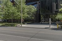 a picture of a city street with parked cars on it and a building across the road