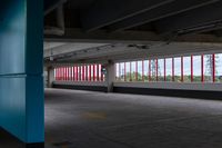 an empty parking lot with colorful stripes on the wall and ceiling and door to another