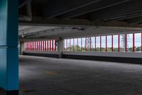 an empty parking lot with colorful stripes on the wall and ceiling and door to another