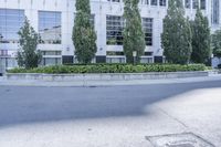 a car driving down an empty street lined with tall buildings and trees in the background