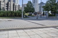 a person sitting at the bench in front of a mall that is empty of people