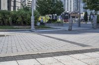 a person sitting at the bench in front of a mall that is empty of people