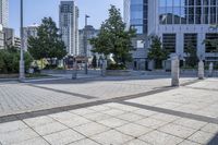 a person sitting at the bench in front of a mall that is empty of people