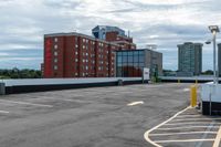 a parking lot with the entrance open and parking spaces marked out for vehicles to park in