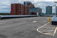 a parking lot with the entrance open and parking spaces marked out for vehicles to park in