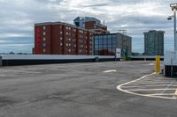 a parking lot with the entrance open and parking spaces marked out for vehicles to park in