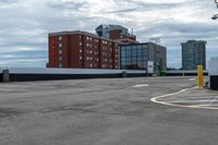 a parking lot with the entrance open and parking spaces marked out for vehicles to park in