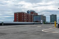 a parking lot with the entrance open and parking spaces marked out for vehicles to park in