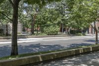 a young girl riding on a skateboard down the street on a city sidewalk in front of some trees