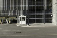 a black parking meter and car wash sign on a sidewalk outside a building with lots of windows