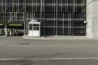 a black parking meter and car wash sign on a sidewalk outside a building with lots of windows