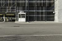 a black parking meter and car wash sign on a sidewalk outside a building with lots of windows