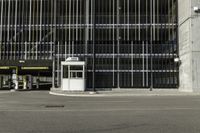 a black parking meter and car wash sign on a sidewalk outside a building with lots of windows