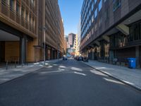 a road through which is a large modern building with an awning over it's entrance