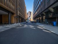 a road through which is a large modern building with an awning over it's entrance