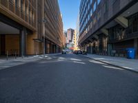 a road through which is a large modern building with an awning over it's entrance