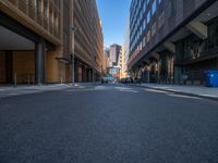 a road through which is a large modern building with an awning over it's entrance