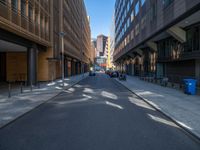 a road through which is a large modern building with an awning over it's entrance