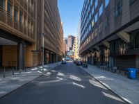 a road through which is a large modern building with an awning over it's entrance