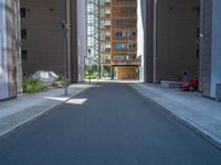 a road through which is a large modern building with an awning over it's entrance