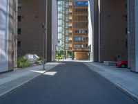 a road through which is a large modern building with an awning over it's entrance