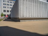 a group of people riding skateboards near wooden panels and stairss with artwork on them