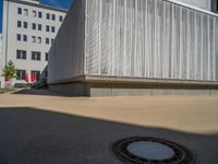 a group of people riding skateboards near wooden panels and stairss with artwork on them