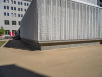 a group of people riding skateboards near wooden panels and stairss with artwork on them