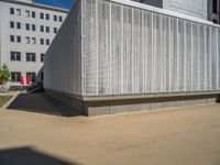 a group of people riding skateboards near wooden panels and stairss with artwork on them