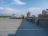 several large empty parking spaces in the city with buildings nearby in front of them -