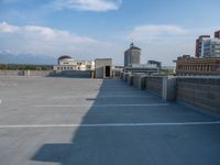 several large empty parking spaces in the city with buildings nearby in front of them -