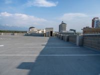 several large empty parking spaces in the city with buildings nearby in front of them -