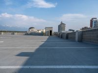 several large empty parking spaces in the city with buildings nearby in front of them -