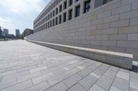 a long, paved walkway with a building in the background and a sky line in the center