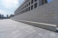 a long, paved walkway with a building in the background and a sky line in the center