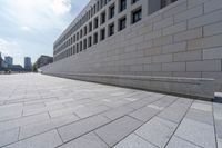 a long, paved walkway with a building in the background and a sky line in the center