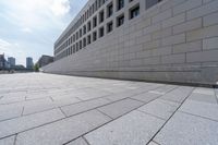 a long, paved walkway with a building in the background and a sky line in the center