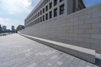 a long, paved walkway with a building in the background and a sky line in the center