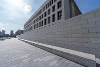 a long, paved walkway with a building in the background and a sky line in the center