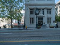 an empty street with buildings and parked cars on the sidewalks and green lanes on the sidewalk